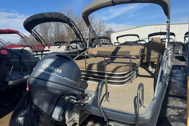 Slide: The Image of 2018 Bennington 23 SSBXP pontoon boat with Yamaha outboard motor, parked outdoors. - 15