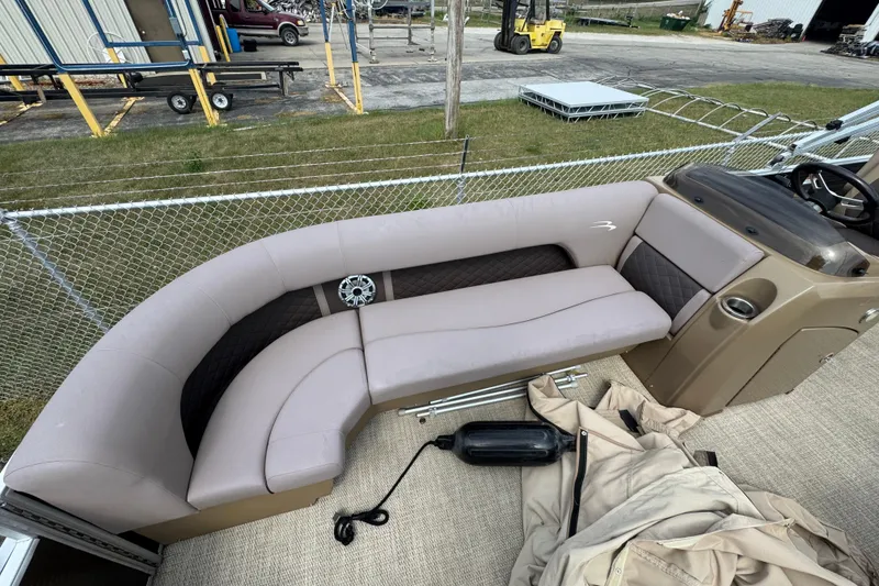 Slide: The Image of 2018 Bennington 23 SSBXP boat interior with beige seating and steering console. - 2