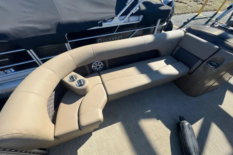 Slide: The Image of 2018 Bennington 23 SSBXP boat interior with beige seating and cup holders. - 8