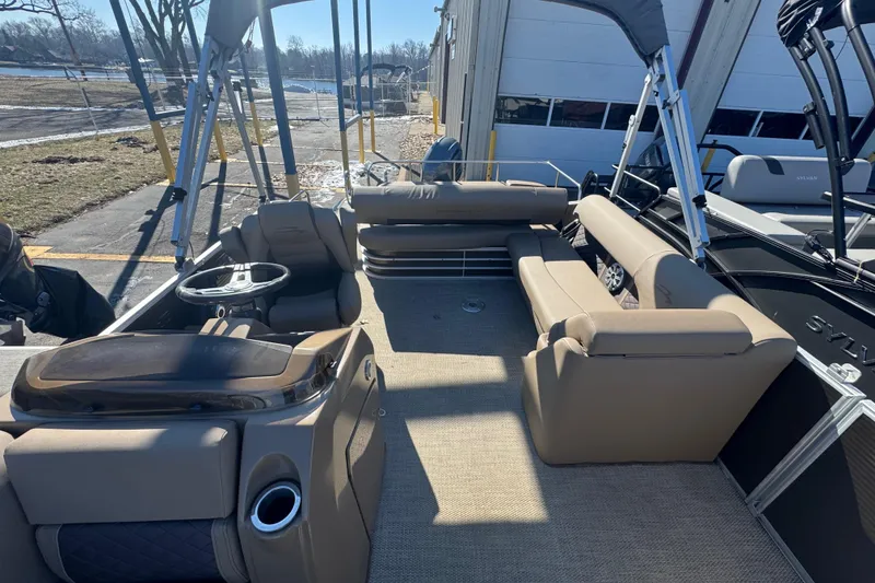 Slide: The Image of 2018 Bennington 23 SSBXP pontoon boat interior with beige seating and steering console. - 9