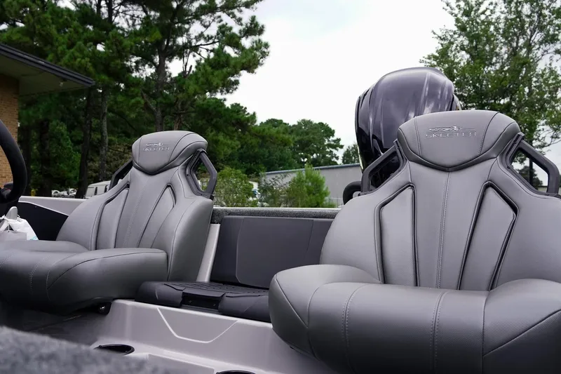Slide: The Image of 2026 Skeeter ZXR20 SE boat seats with sleek design, set against a natural backdrop. - 26
