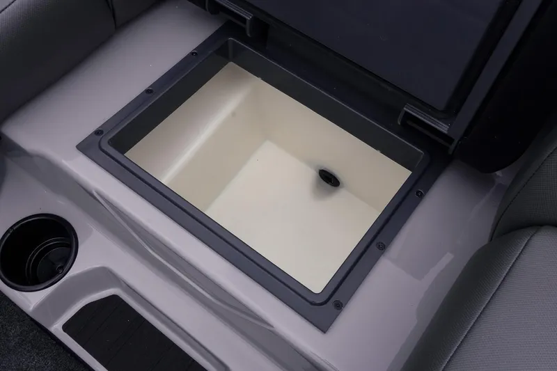 Slide: The Image of Storage compartment in 2026 Skeeter ZXR20 SE boat, featuring sleek design and cup holder. - 33