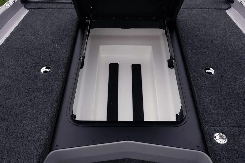 Slide: The Image of Open storage compartment on 2026 Skeeter ZXR20 SE boat, featuring carpeted deck. - 37