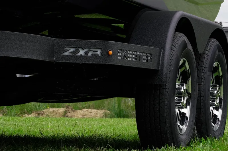 Slide: The Image of 2026 Skeeter ZXR20 SE trailer with dual wheels on grass. - 46