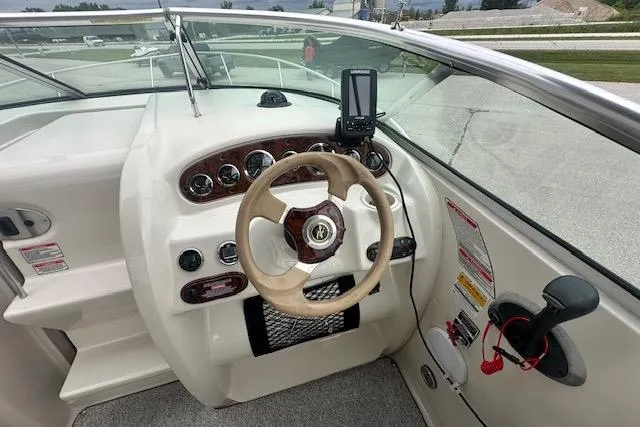 Slide: The Image of 2002 Sea Ray 225 Weekender boat dashboard with steering wheel and navigation equipment. - 13