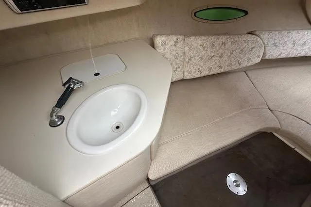 Slide: The Image of Interior of 2002 Sea Ray 225 Weekender boat with sink and seating area. - 15