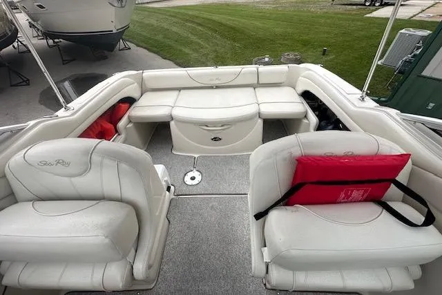 Slide: The Image of Interior of 2002 Sea Ray 225 Weekender boat with white seating and red life jackets. - 16