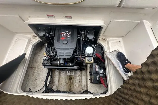 Slide: The Image of Engine compartment of a 2002 Sea Ray 225 Weekender boat, showcasing the motor and components. - 17