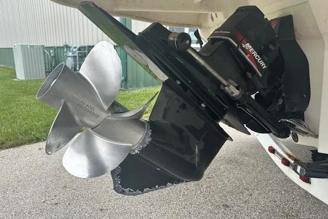 Slide: The Image of 2002 Sea Ray 225 Weekender boat propeller and Mercury outdrive on display. - 8