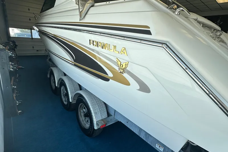 Slide: The Image of 2005 Formula 280 Sun Sport boat on trailer in indoor storage. - 3