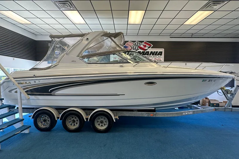 Slide: The Image of 2005 Formula 280 Sun Sport boat on trailer in showroom setting. - 8