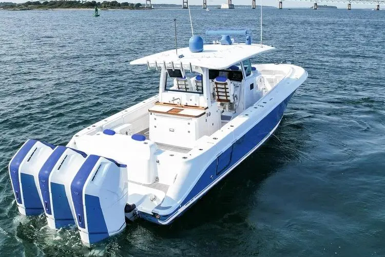 Slide: The Image of 2025 HCB 42 Lujo boat with triple engines cruising on open water. - 1