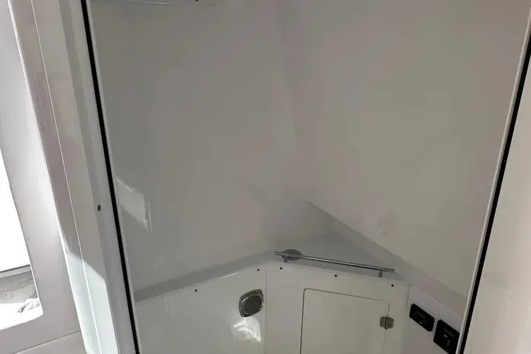 Slide: The Image of Interior view of 2025 HCB 42 Lujo boat, featuring sleek white cabin design. - 12