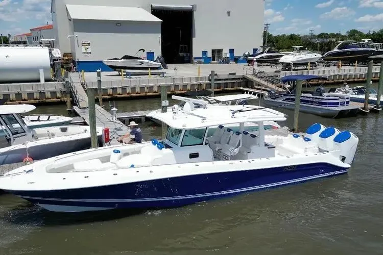 Slide: The Image of 2025 HCB 42 Lujo boat docked at marina, featuring sleek design and spacious deck. - 15