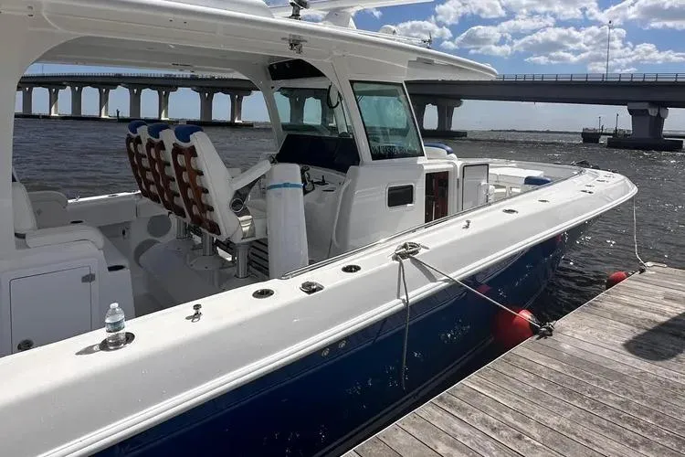 Slide: The Image of 2025 HCB 42 Lujo boat docked by a bridge on a sunny day. - 17