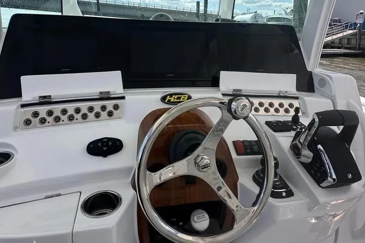 Slide: The Image of 2025 HCB 42 Lujo boat dashboard with steering wheel and control panel. - 18