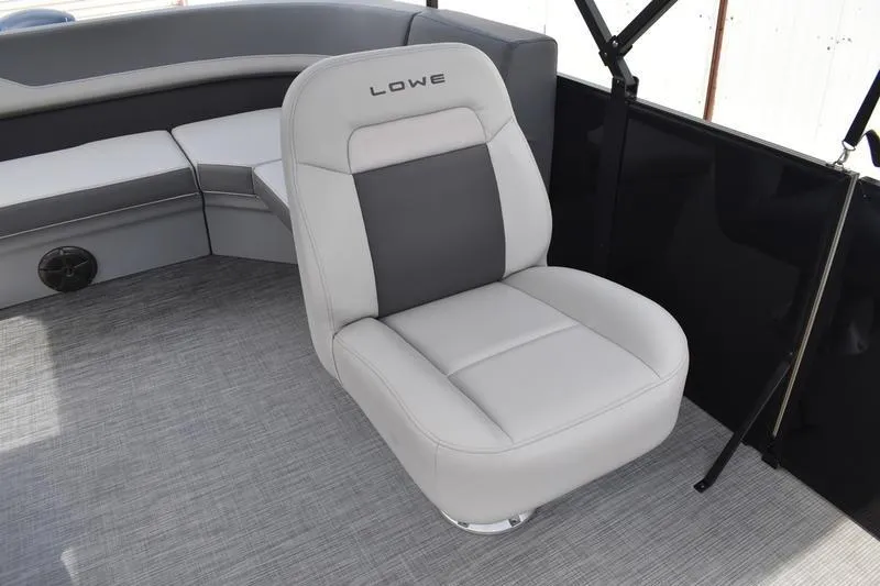 Slide: The Image of 2026 Lowe LS 190 boat interior with gray cushioned seating and built-in speakers. - 43