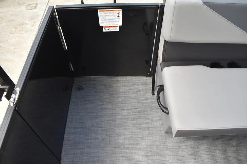 Slide: The Image of 2026 Lowe LS 190 boat storage compartment with wiring and cup holders. - 47
