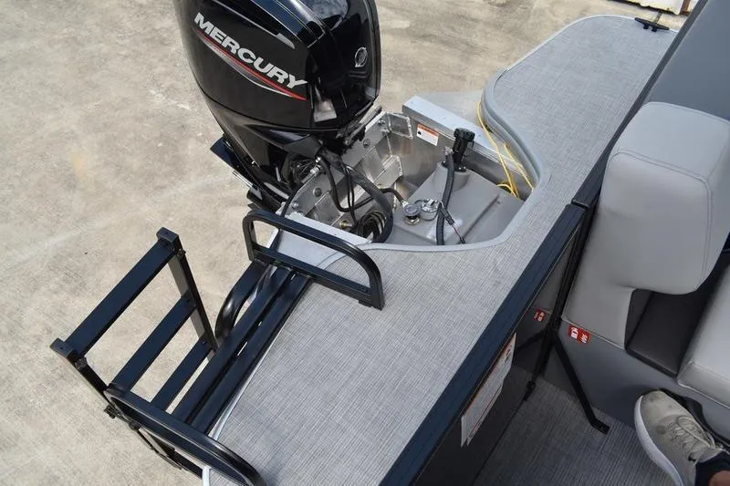 Slide: The Image of 2026 Lowe LS 190 boat with Mercury outboard motor, parked on a trailer. - 7