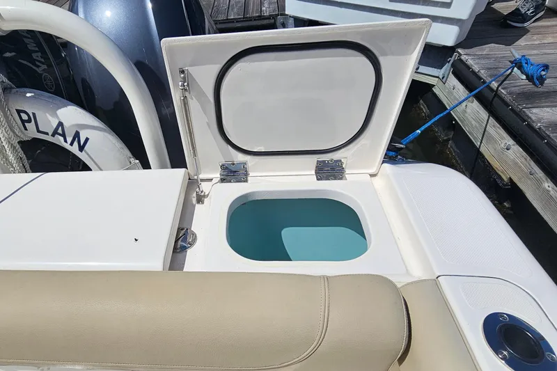 Slide: The Image of 2016 Pursuit DC 265 Dual Console boat with open storage compartment on deck. - 10