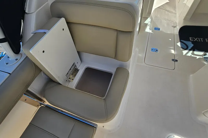 Slide: The Image of 2016 Pursuit DC 265 Dual Console boat interior seating and storage compartment. - 11