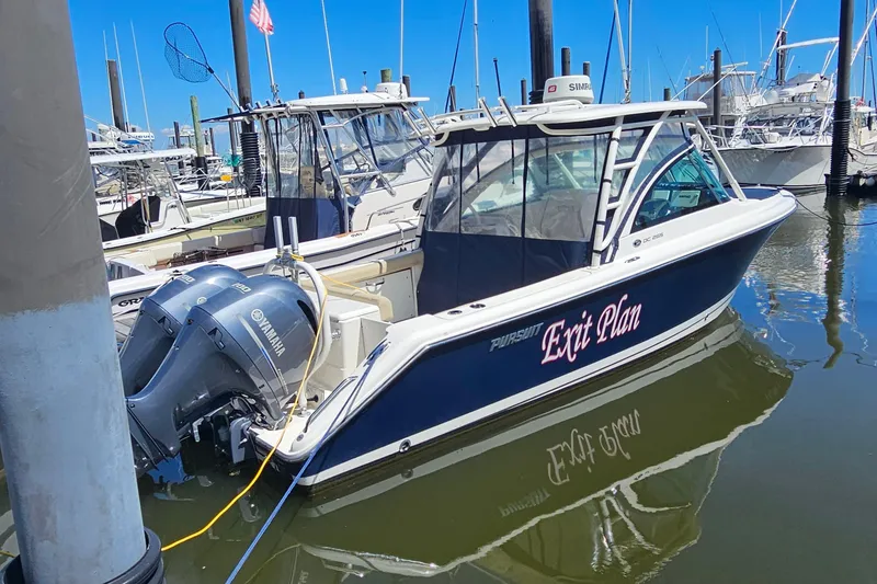 Slide: The Image of 2016 Pursuit DC 265 Dual Console boat docked with twin Yamaha engines. - 30