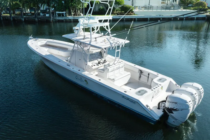 Slide: The Image of 2009 SeaHunter 40 boat with triple outboard engines on calm water. - 10