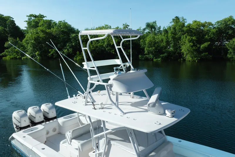 Slide: The Image of 2009 SeaHunter 40 boat with multiple outboard motors on a calm river. - 12