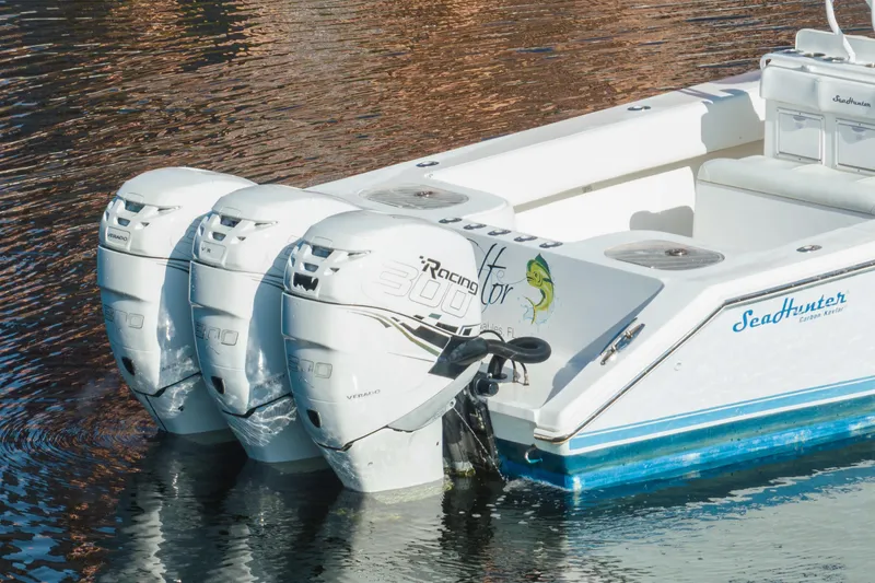 Slide: The Image of 2009 SeaHunter 40 boat with triple 300 horsepower engines on calm water. - 14