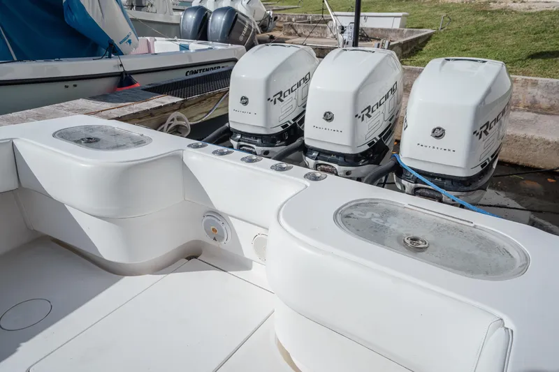 Slide: The Image of 2009 SeaHunter 40 boat with four powerful outboard engines docked at marina. - 15