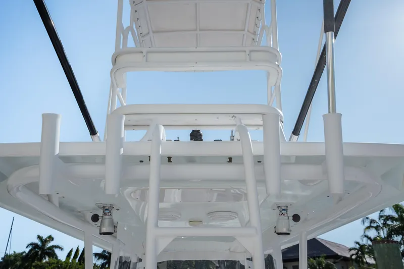 Slide: The Image of 2009 SeaHunter 40 boat tower against clear blue sky, showcasing sleek design and structure. - 19