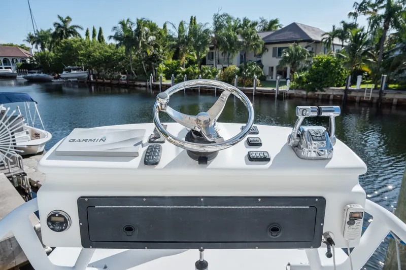 Slide: The Image of Helm of 2009 SeaHunter 40 boat with Garmin navigation, docked by waterfront homes. - 22