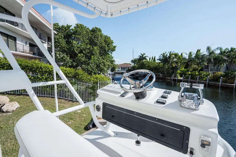 Slide: The Image of 2009 SeaHunter 40 boat helm with waterway and lush greenery in the background. - 23