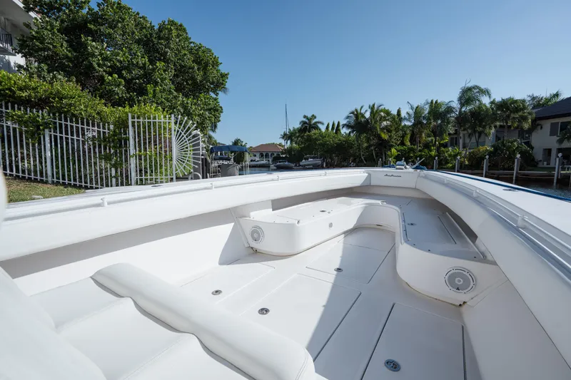 Slide: The Image of 2009 SeaHunter 40 boat with spacious deck, docked near lush greenery and waterfront homes. - 25