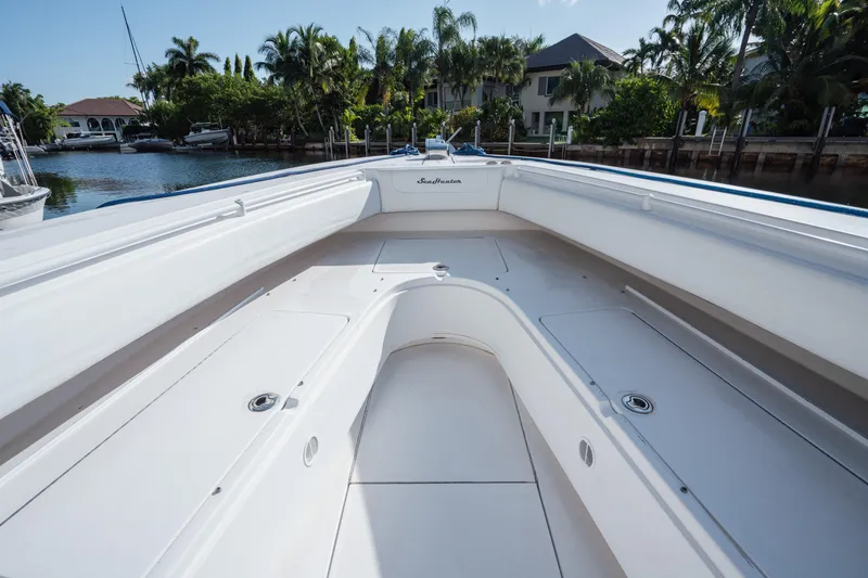 Slide: The Image of 2009 SeaHunter 40 boat interior with spacious deck, docked near waterfront homes. - 28