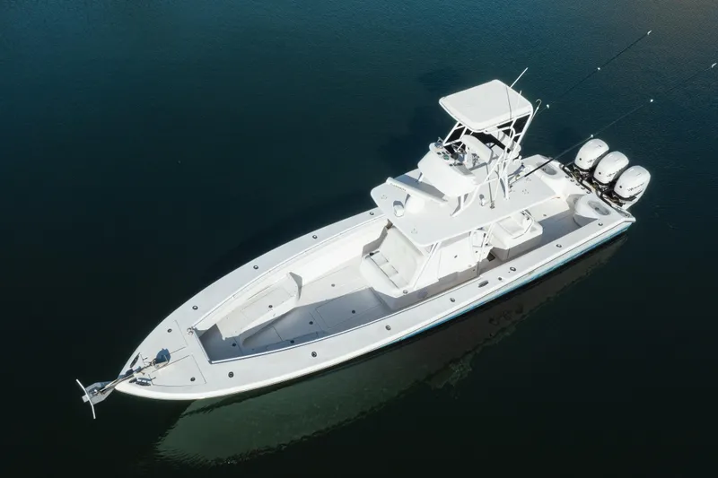 Slide: The Image of Aerial view of 2009 SeaHunter 40 boat with triple outboard engines on calm water. - 6