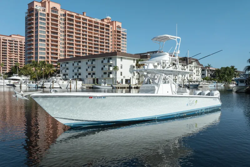Slide: The Image of 2009 SeaHunter 40 boat docked in marina, with waterfront buildings in background. - 8