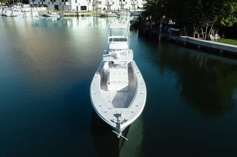 Slide: The Image of 2009 SeaHunter 40 boat docked in a serene marina setting. - 9