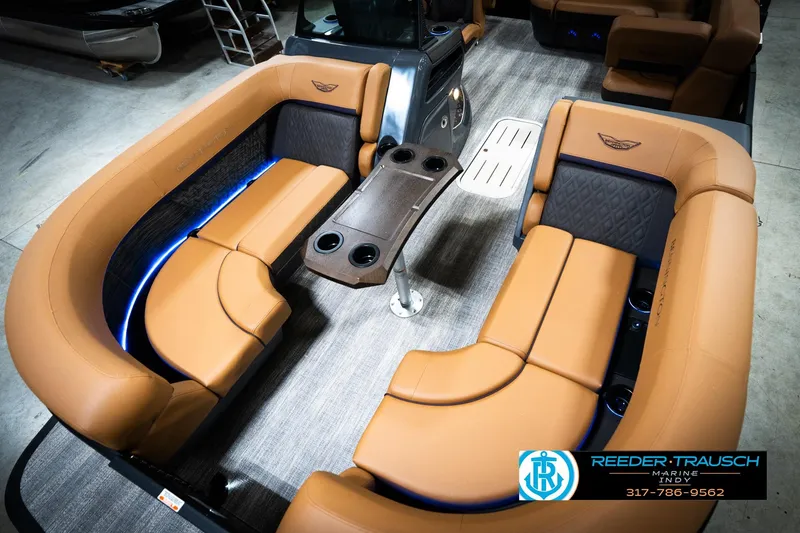 Slide: The Image of Luxurious interior of 2026 Bennington 22 MSB pontoon boat with tan seating and LED lighting. - 10