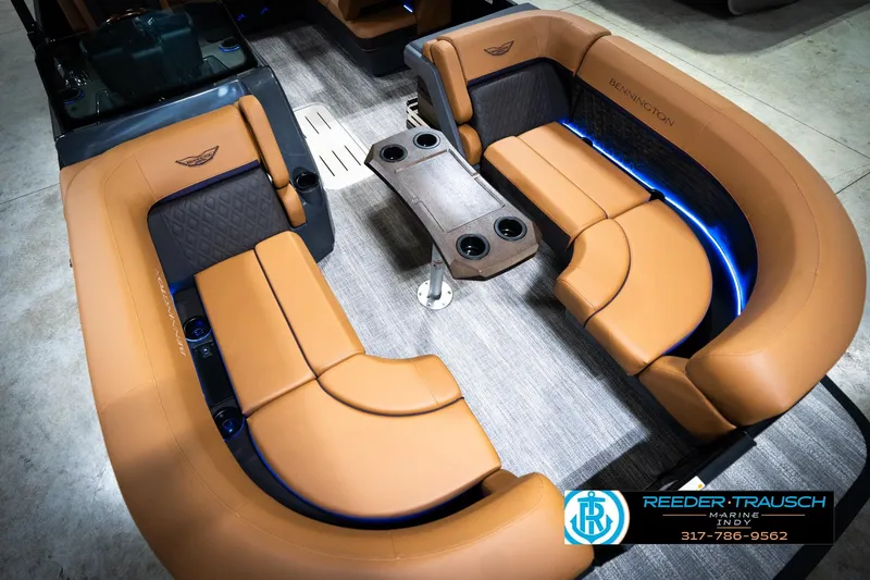Slide: The Image of Luxurious interior of 2026 Bennington 22 MSB pontoon boat with tan seating and blue lighting. - 11