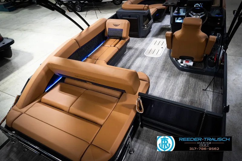 Slide: The Image of 2026 Bennington 22 MSB pontoon boat interior with tan seating and modern dashboard. - 12