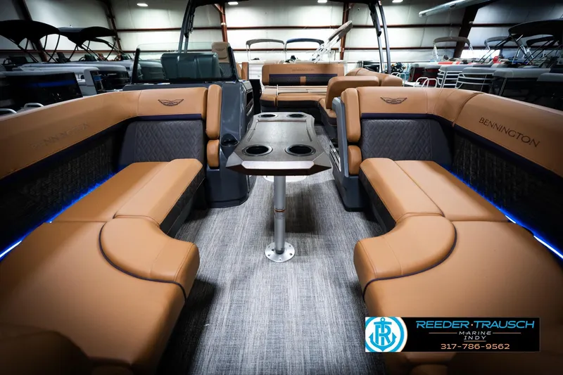 Slide: The Image of Luxurious interior of 2026 Bennington 22 MSB pontoon boat with tan seating and table. - 14