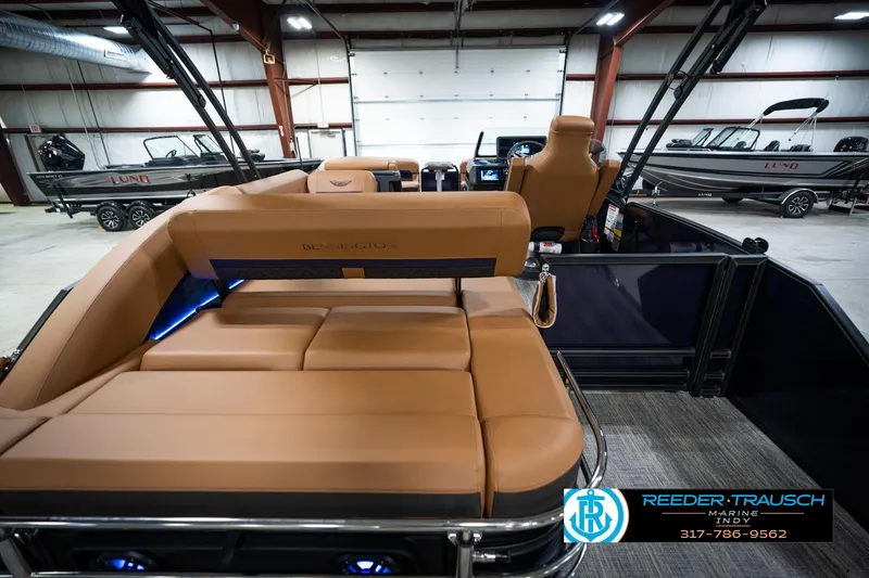 Slide: The Image of 2026 Bennington 22 MSB pontoon boat with tan seating in showroom. - 17