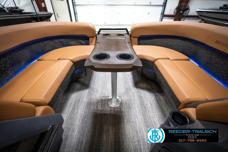 Slide: The Image of 2026 Bennington 22 MSB boat interior with tan seating and blue LED lighting. - 19