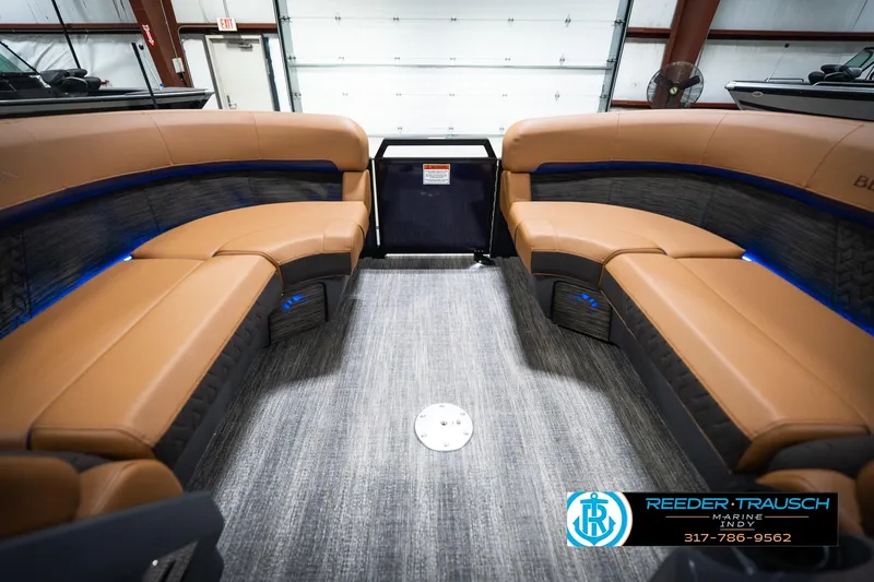 Slide: The Image of Interior of 2026 Bennington 22 MSB pontoon boat with tan seating and blue lighting. - 20