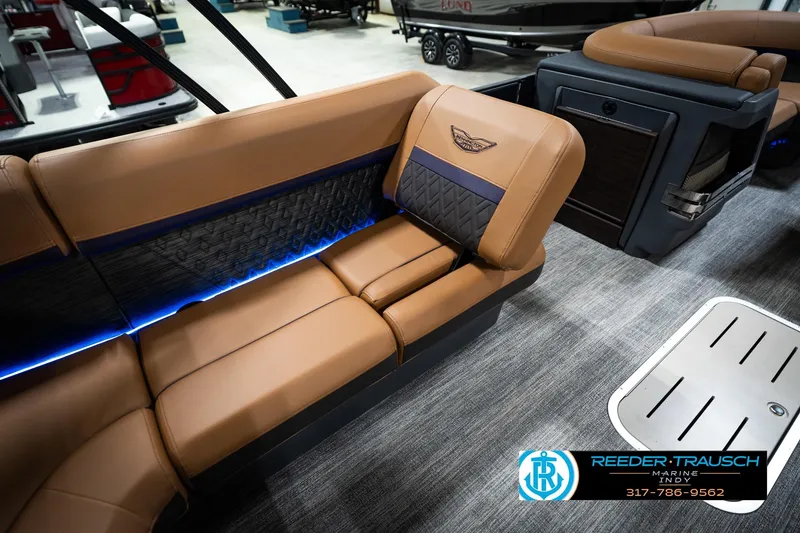 Slide: The Image of Luxurious interior of 2026 Bennington 22 MSB pontoon boat with tan seating and blue lighting. - 24