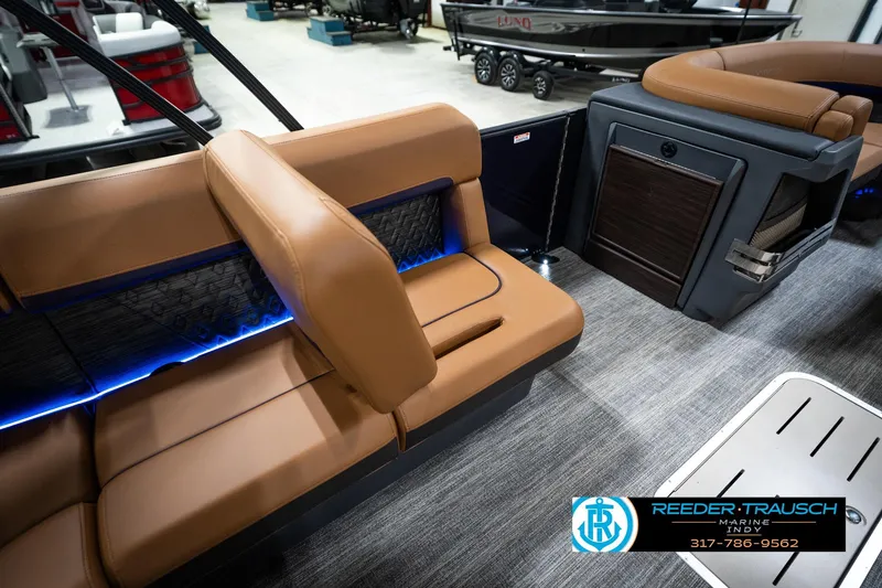 Slide: The Image of 2026 Bennington 22 MSB boat interior with tan seating and blue LED lighting. - 25