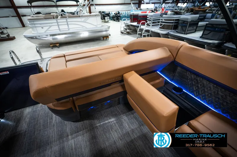Slide: The Image of 2026 Bennington 22 MSB pontoon boat interior with tan seating and blue LED lighting. - 27