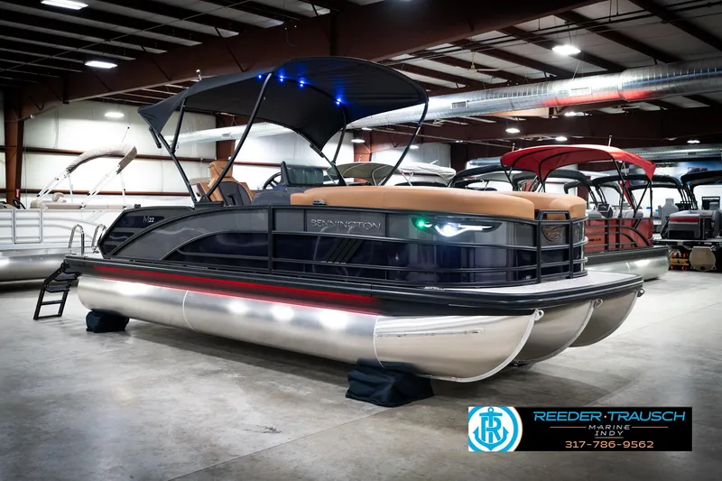 Slide: The Image of 2026 Bennington 22 MSB pontoon boat in showroom with canopy and sleek design. - 4