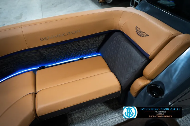 Slide: The Image of 2026 Bennington 22 MSB boat interior with tan leather seating and blue LED lighting. - 43